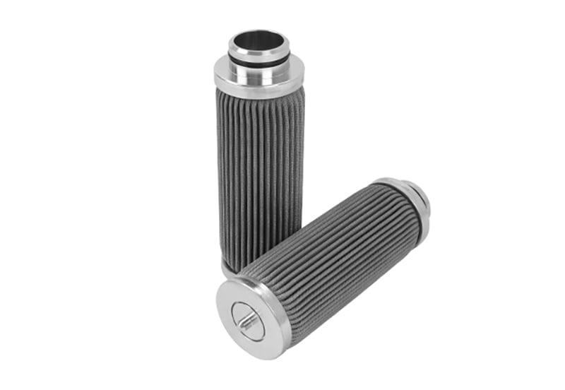 Compact pleated stainless steel filter cartridges on white background