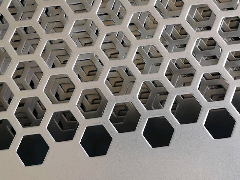 Close view of custom hexagonal openings in stacked metal sheets