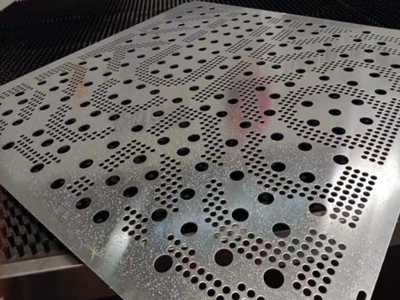 Custom perforated metal panel with mixed round hole pattern