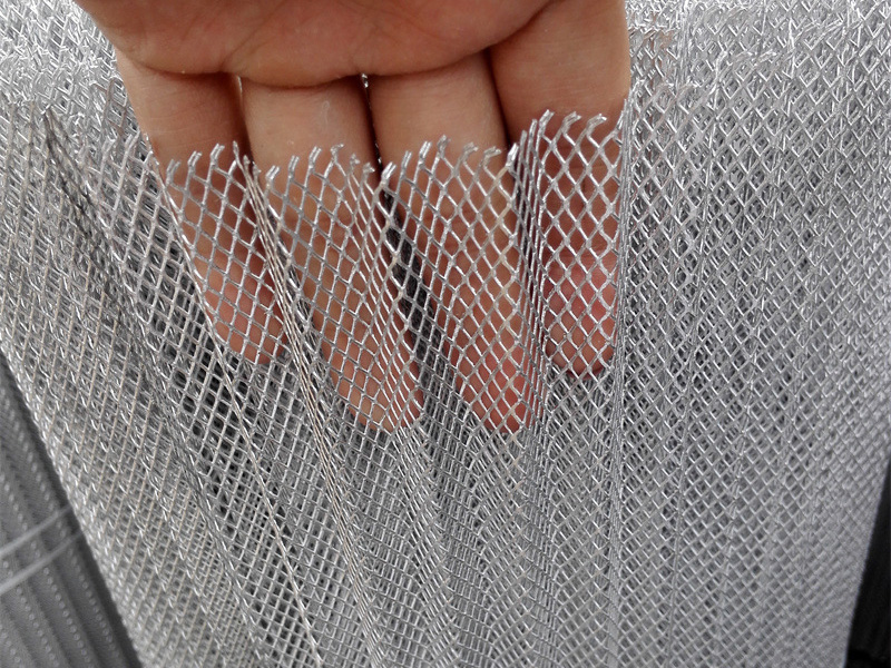 Fine expanded metal mesh sheet showing material flexibility