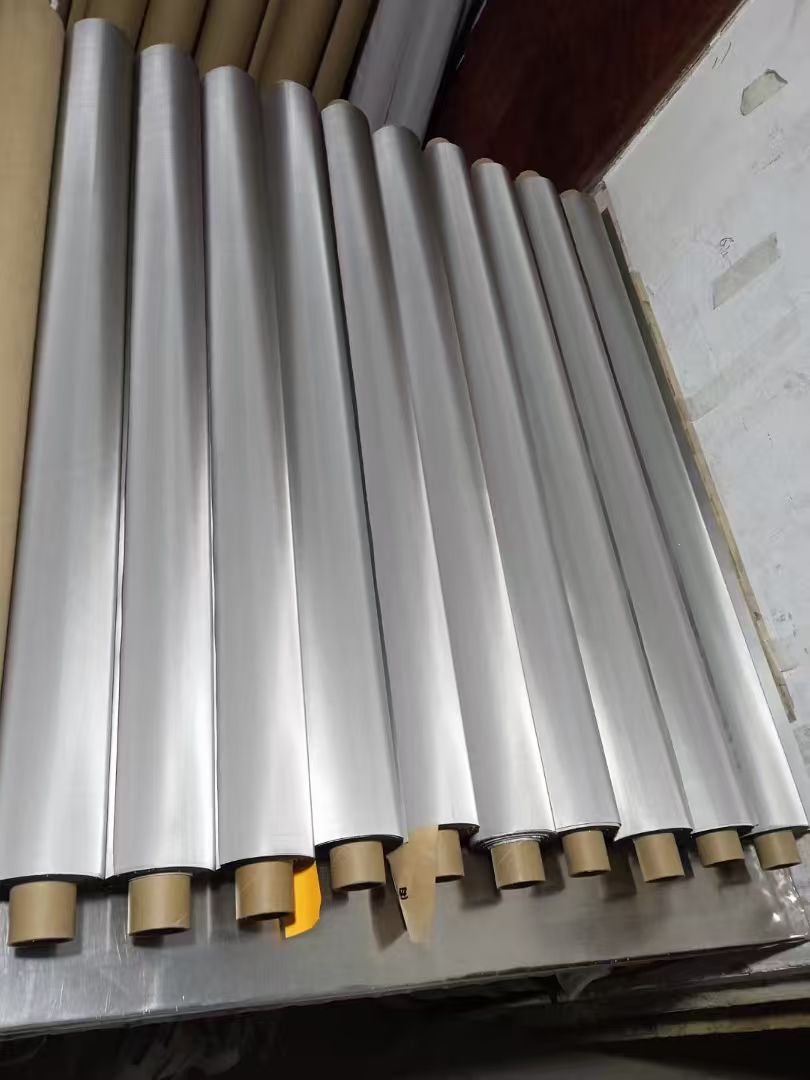 Long rolls of fine metal filter mesh on cardboard cores