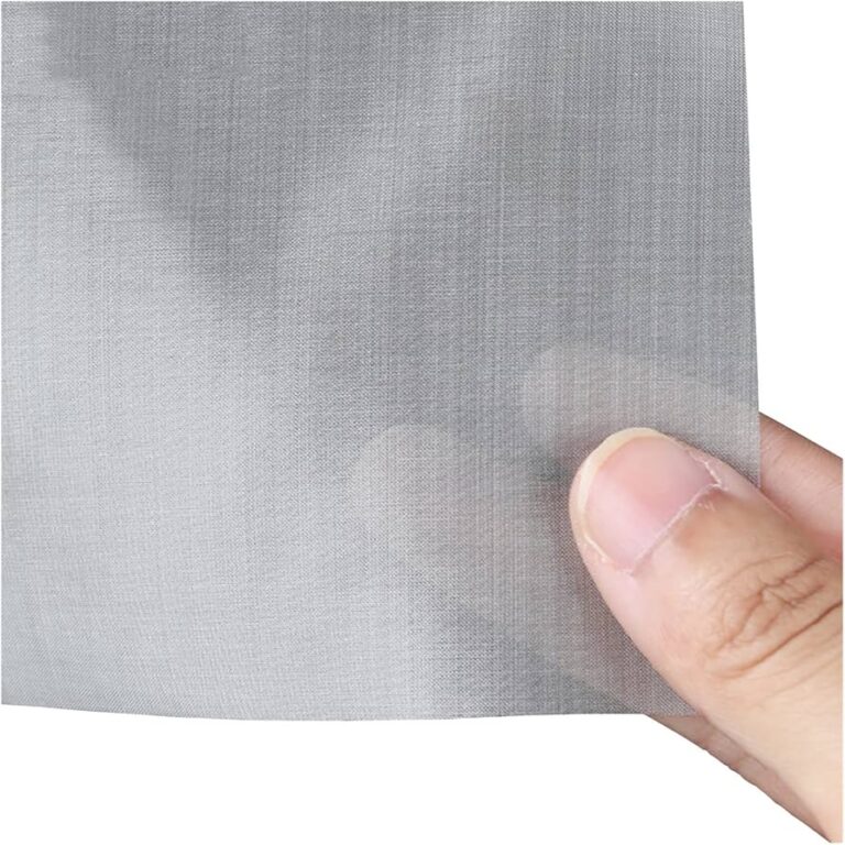 Fine stainless steel woven mesh sheet held for scale