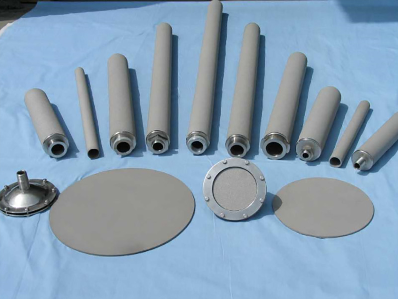 Porous metal cylindrical and disc filter forms arranged for comparison