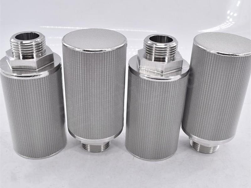 Four cylindrical sintered metal filter elements with threaded fittings and closed ends